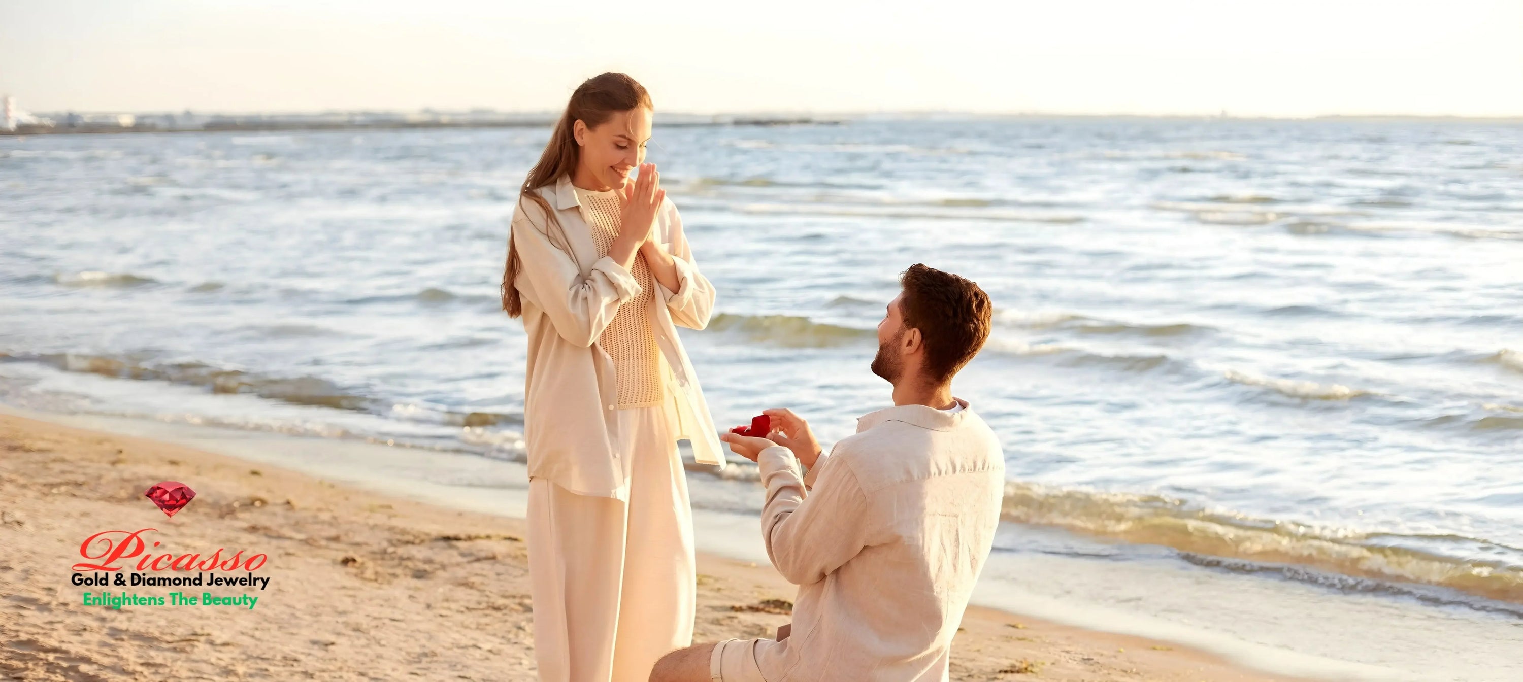 Man proposing with diamond engagement ring on a beach, woman smiling, ocean in background