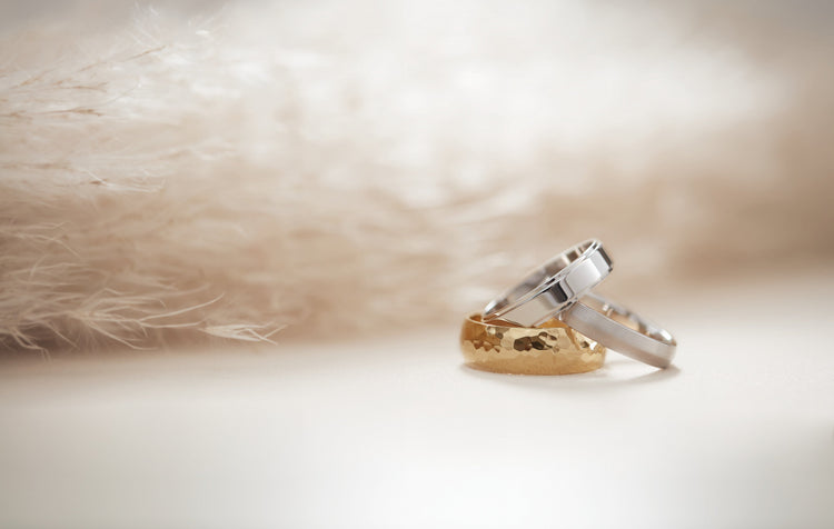 Two-tone gold bands and diamond rings in soft natural light – Picasso Gold & Diamond Chicago