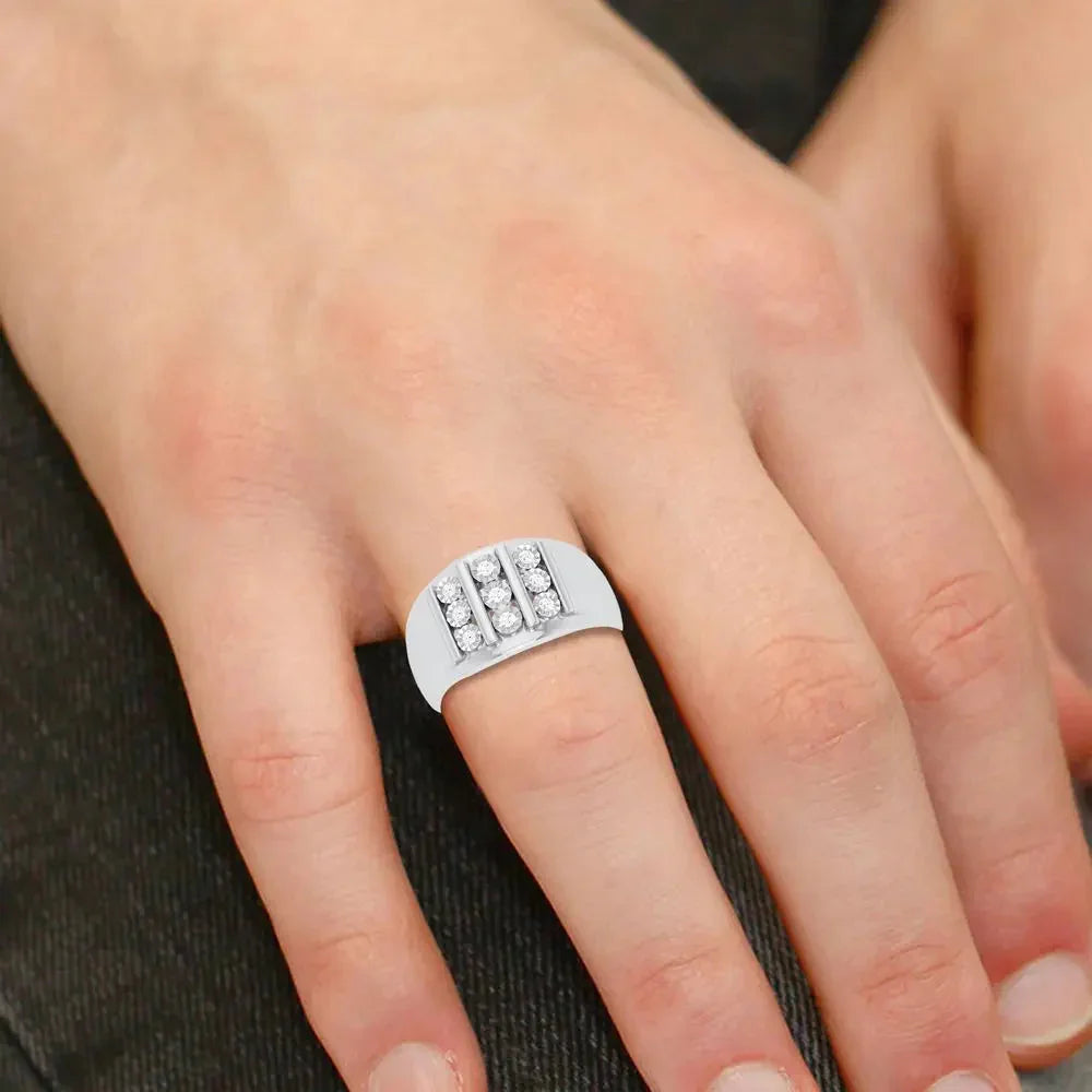 Wide band white gold and diamond ring with three vertical rows, worn on hand
