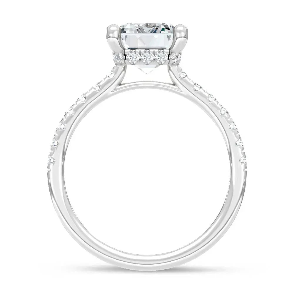 White gold engagement ring with round center diamond and pavé diamond band, side view.