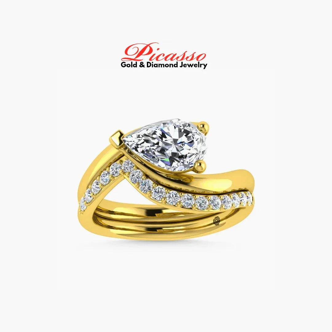 Gold engagement ring with pear-shaped diamond and pavé diamond band on white background