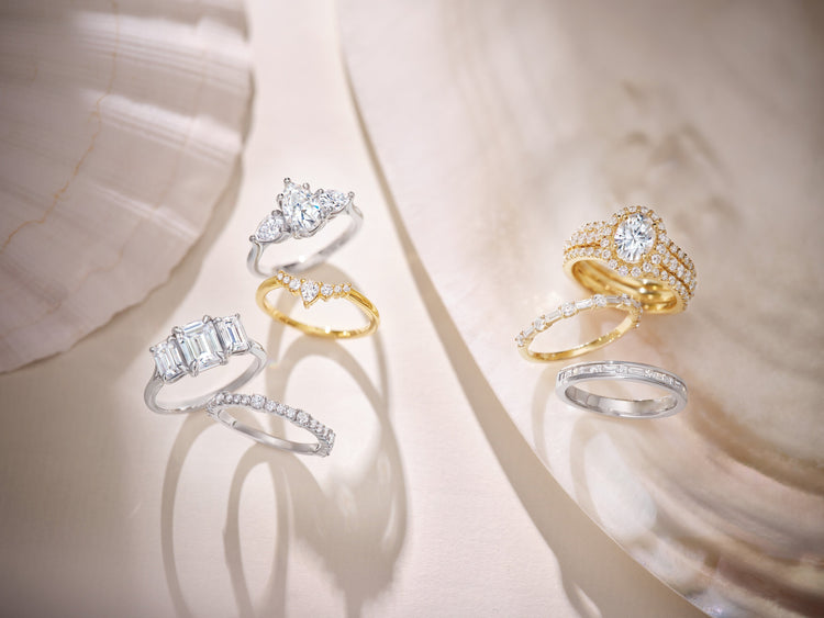 Lab-grown diamond three-stone, halo and emerald-cut engagement rings on blush shell – Picasso Gold & Diamond Chicago