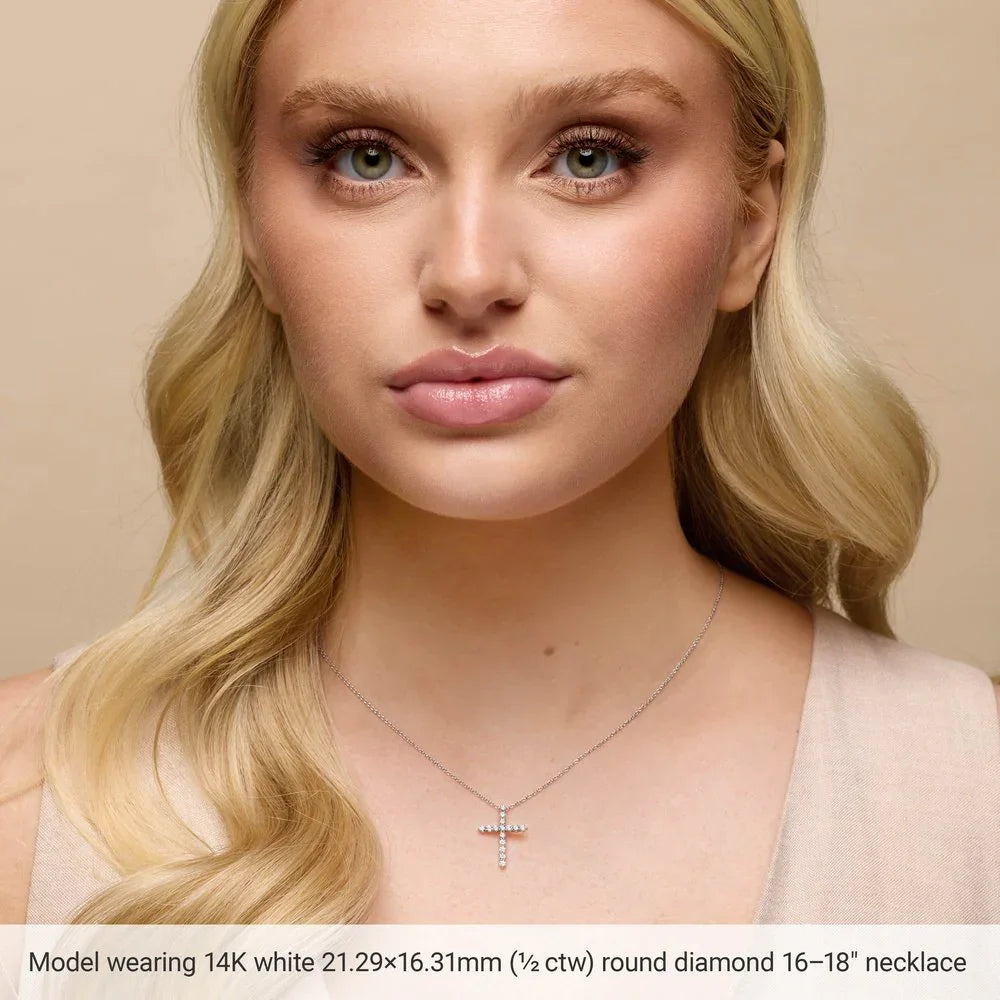 Woman wearing 14K white gold cross necklace with round diamonds, close-up on neck and face