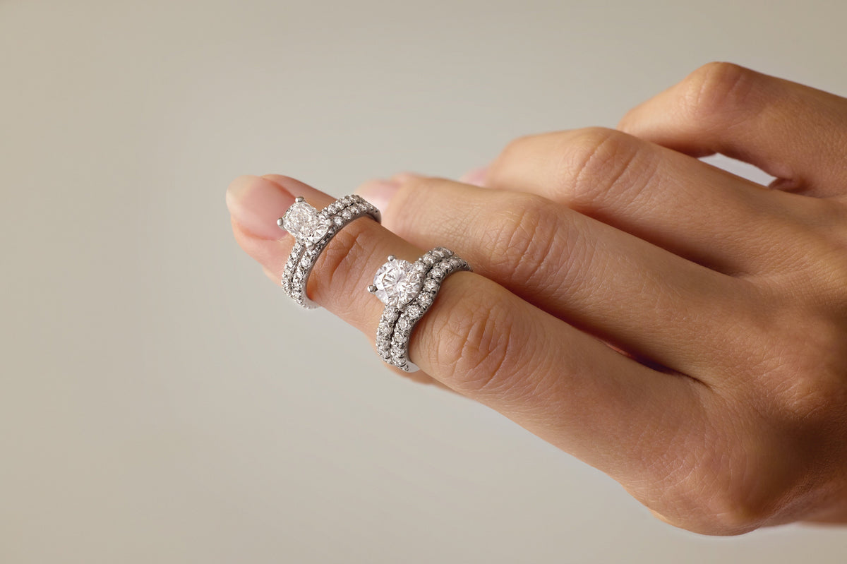 Diamond engagement ring and pavé wedding band stack worn on hand – Picasso Gold & Diamond Chicago