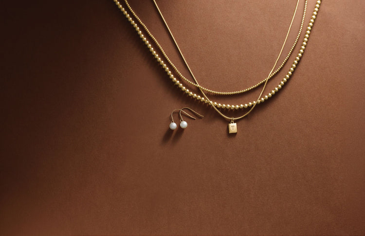 Layered yellow gold chain necklaces with bead and pendant details – Picasso Gold & Diamond Chicago