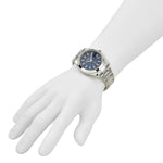 Silver watch with a blue face on a white mannequin wrist