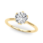 Gold ring with a diamond on a white background