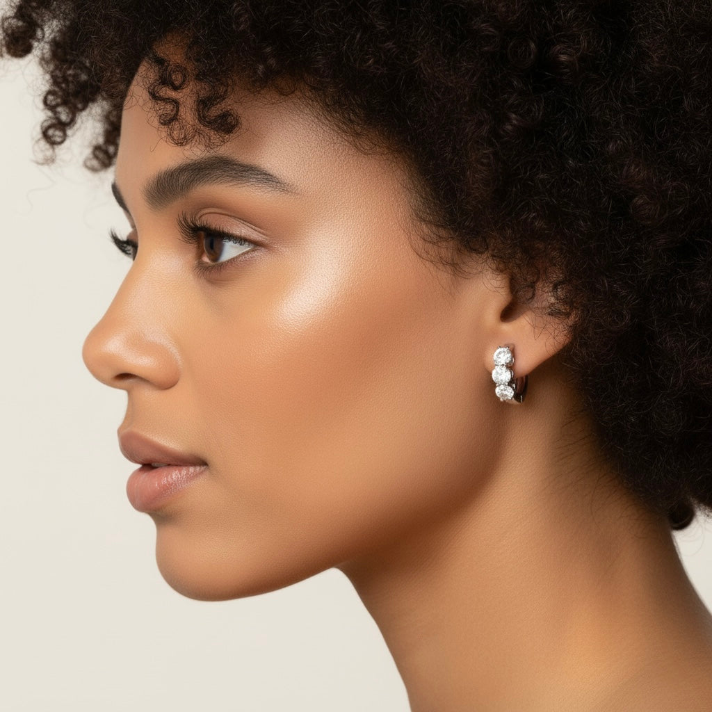 Classic 14k White Gold huggie earrings, featuring lab-grown diamond accents, angled close-up view.
