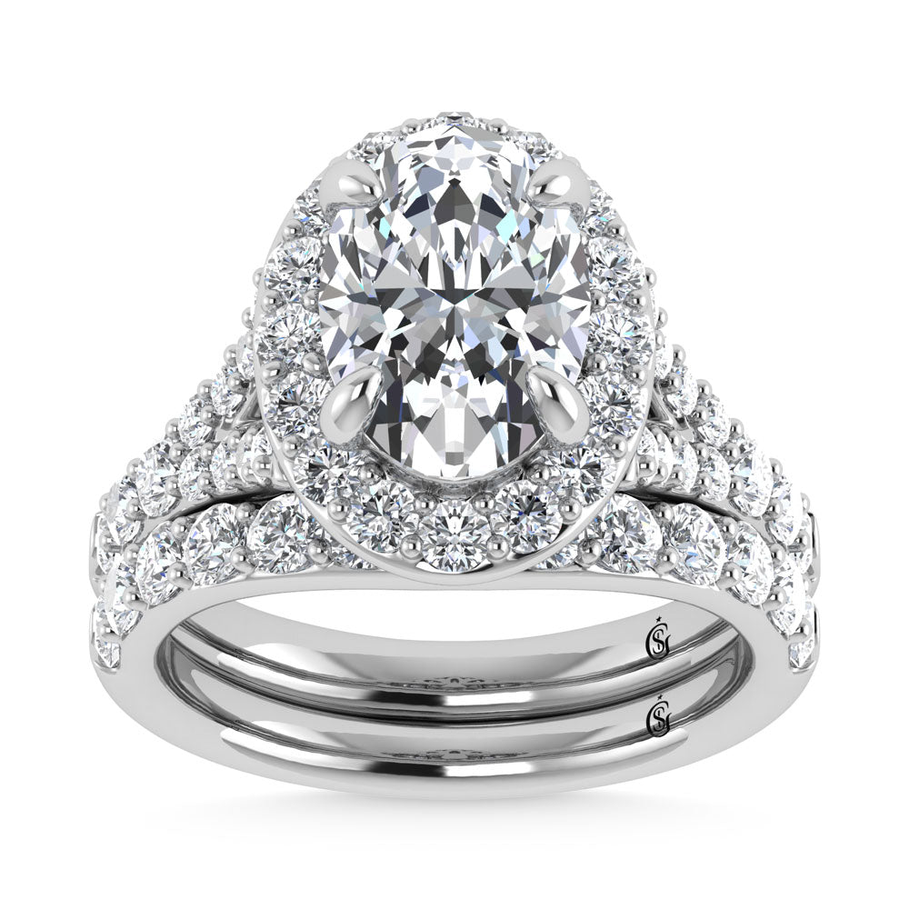 Oval diamond engagement ring with halo and matching band, set in white gold with pave diamonds