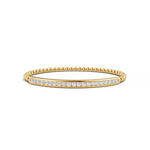 14k Yellow Gold diamond bangle, set with 1.49 CTW lab grown diamond, with round-cut stones, close-up detail shot.