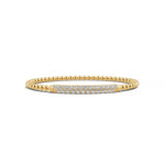 Elegant 14k Yellow Gold diamond bangle, set with 1.33 CTW lab grown diamond, with round-cut stones, close-up detail shot.