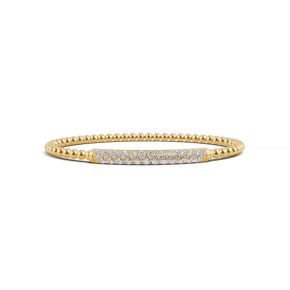 Elegant 14k Yellow Gold diamond bangle, set with 1.33 CTW lab grown diamond, with round-cut stones, close-up detail shot.