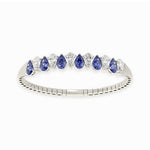14k White Gold diamond bangle, set with 12 CTW lab diamond / lab blue sapphire, with pear-cut stones, close-up detail shot.