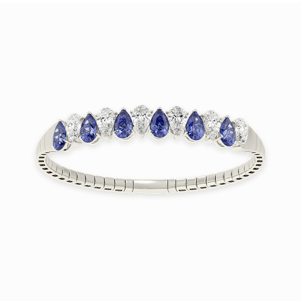 14k White Gold diamond bangle, set with 12 CTW lab diamond / lab blue sapphire, with pear-cut stones, close-up detail shot.