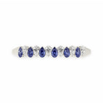 Elegant 14k White Gold diamond bangle, set with 12 CTW lab diamond / lab blue sapphire, side profile view.