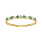 14k Yellow Gold diamond bangle, showcasing 11 CTW lab diamond / lab emerald, in a round cut, close-up detail shot.