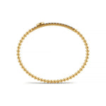 Handcrafted 14k Yellow Gold diamond bangle, featuring 2 CTW lab grown diamond, worn lifestyle shot, Chicago fine jewelry, nationwide shipping.
