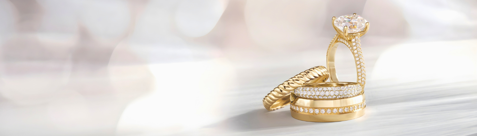 Gold ring with wheat design on a soft, blurred background